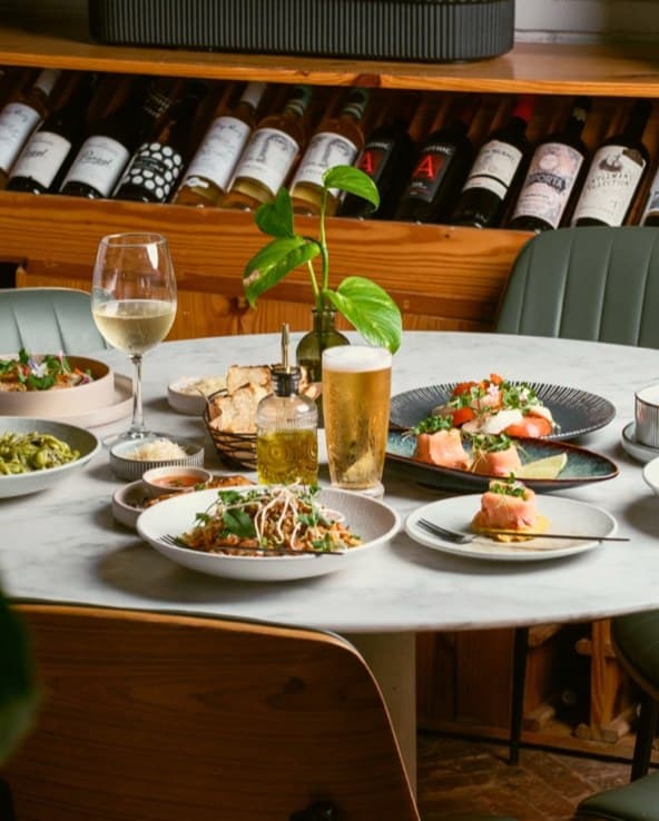 The long table set under warm light
