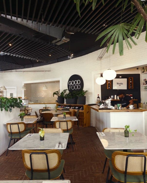 The dining room, marble tables under the good food sign