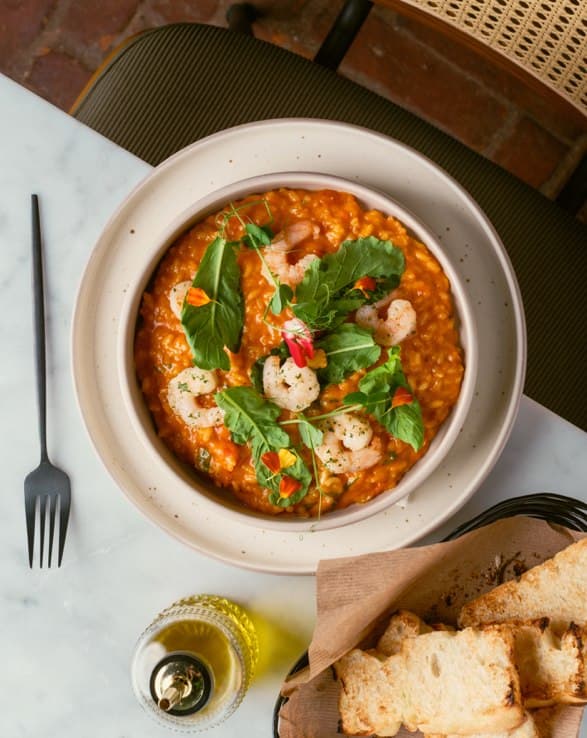 Shrimp risotto finished with garden herbs