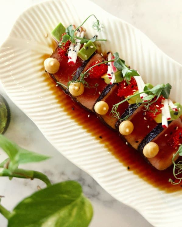 Tuna tataki on a ridged ceramic plate